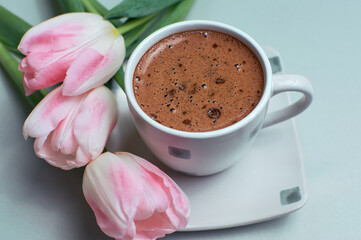 Hot coffee cup with tulip bouquet