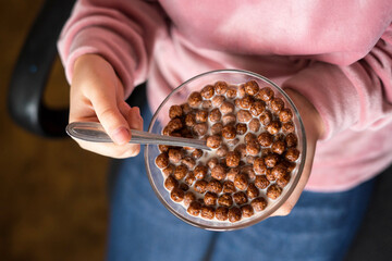 girl eating Chocolate Cereal