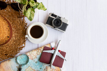 Traveler accessories and cup coffee with tourism backpack and visiting for planning airplane trips...