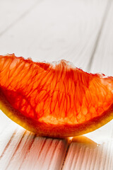 Fresh grapefruit slice on white background close-up.
