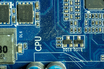 macro shots of microcircuits and transistors on the dusty motherboard of a working personal computer