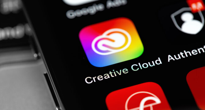 Adobe Creative Cloud mobile app icon on screen smartphone, iPhone closeup. Adobe Creative Cloud - a suite of cross-platform applications from Adobe Systems. Moscow, Russia - February 16, 2021