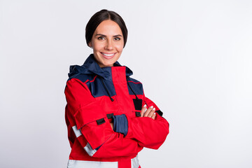Photo of positive charming young lady paramedic dressed red uniform smiling hands folded isolated...