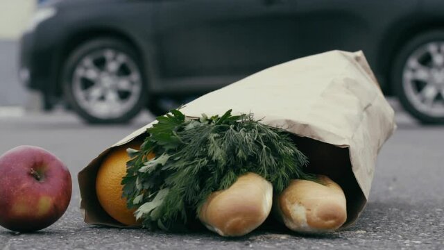The bag of groceries fell to the pavement. Slow motion.
