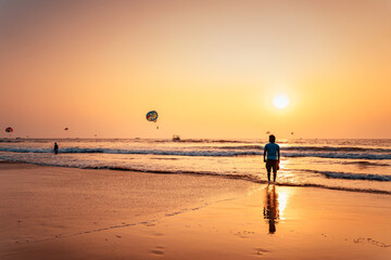 Fototapeta na wymiar Man standing near beach shore alone