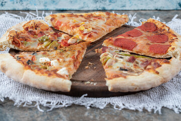 Various kind of pizza slices. Pepperoni, mozzarella and mixed