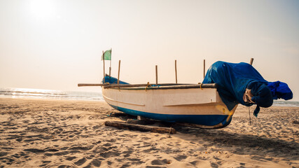 Boat lying on the side of a beach