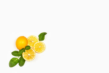 Fresh mint and lemons on white background with copy space. Healthy background with mint leaf and lemon fruits