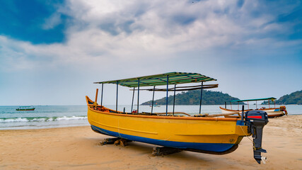 Yellow boat lying on the beach shore