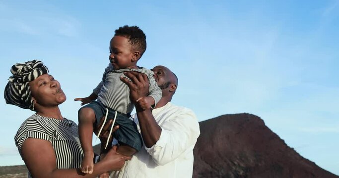 Happy african family having fun on the beach - Parents and child love concept
