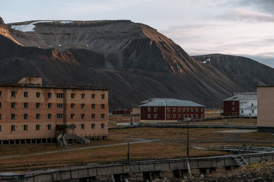 Ruined building with mountain in the background in the Ghost Town of Pyramiden, Svalbard