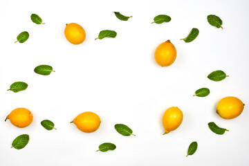 Fresh mint and lemons on white background with copy space. Healthy background with mint leaf and lemon fruits
