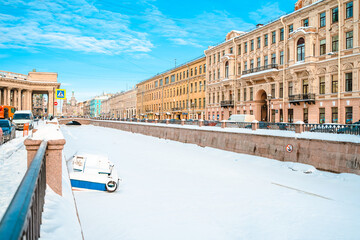 View of the snow-covered river and panorama of a beautiful historical street in the center of St....