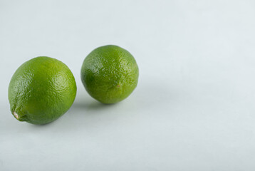 Two fresh lime. Close up photo. Organic citrus fruit