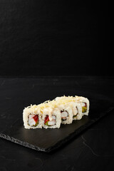 white rolls on black wooden board on black wooden background