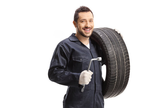 Auto mechanic holding a tire and a lug wrench