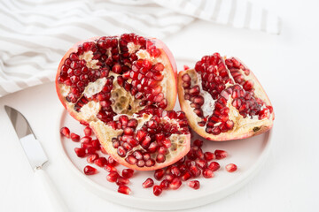 Fresh ripe pomegranate in a plate, pomegranate seeds