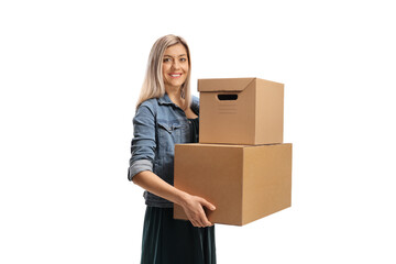 Young cheerful woman carrying two cardboard boxes