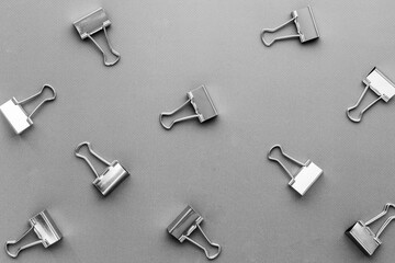 Paper binder clips. Stationery and office supplies background.