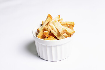 Homemade croutons in bowl isolated on white background