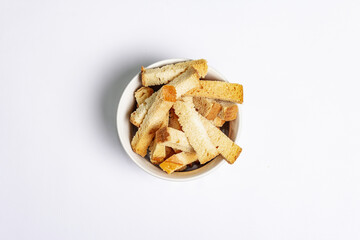 Homemade croutons in bowl isolated on white background