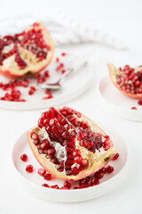Fresh ripe pomegranate in a plate, pomegranate seeds