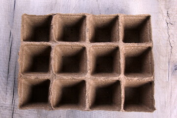 Empty peat pots on gray wooden background. Peat pots for seedling