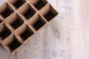 Empty peat pots on gray wooden background. Peat pots for seedling