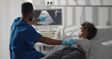 Young afro-american pregnant woman in safety at ultrasound office in modern clinic.