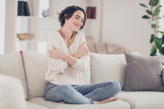 Full Size Portrait Of Pretty Peaceful Lady Sit On Sofa Hands Cuddle Shoulder Enjoy Free Time Home Indoors