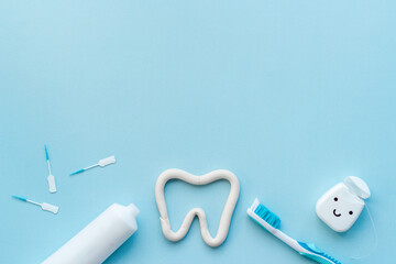 Oral care products flat lay. Toothbrushes with white tube of toothpaste and dental floss