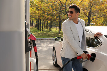 Man refueling car at self service gas station