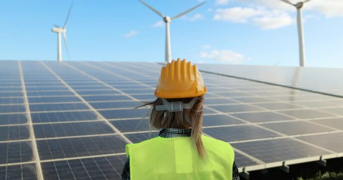 Young woman working at renewable energy farm - Eco and technology concept