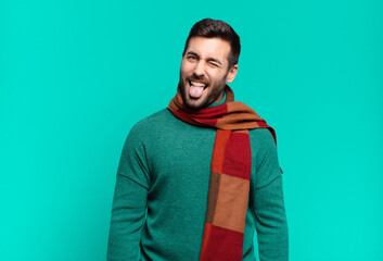 young handsome man with cheerful, carefree, rebellious attitude, joking and sticking tongue out,...