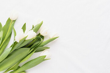 white tulip bouquet on white fabric background for mock up design