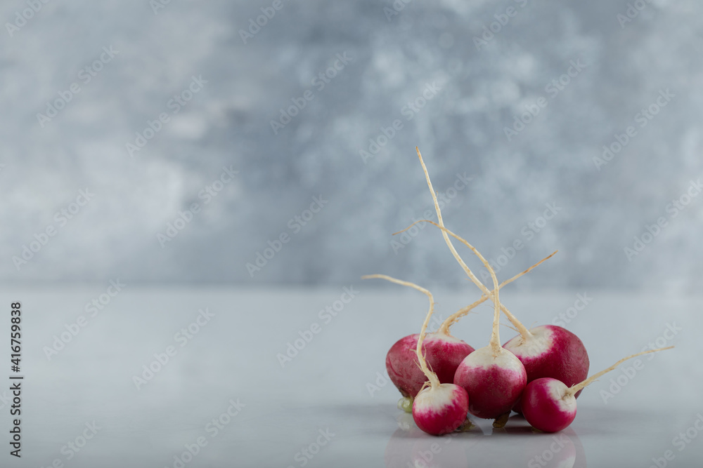 Wall mural wide angle photo of fresh organic radishes on white background