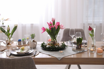 Beautiful Easter table setting with beautiful flowers indoors