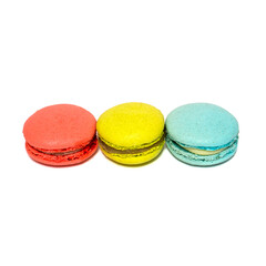 Red Yellow Blue Macaroons isolated in white background. Colorful french macarons close-up. Tasty sweet color macaroon, bakery concept
