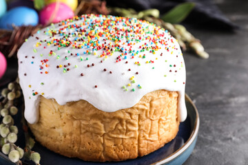 Traditional Easter cake and painted eggs on black table, closeup
