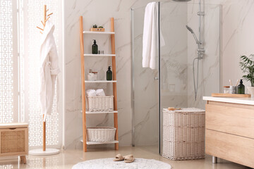 Obraz na płótnie Canvas Modern bathroom interior with decorative ladder and shower stall