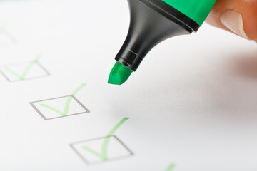 The green marker on the check sheet with markings in the form of ticks.