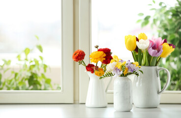 Different beautiful spring flowers on window sill. Space for text