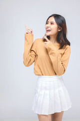 Portraits of young Asian women. Thumbs up With a smiling face happily, a beautiful woman with a sense of self-confidence, looks good, happy on a gray background.