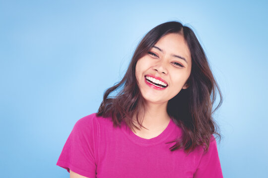 Portrait of a beautiful woman Asian teenagers With a confident, happy face, a confident, beautiful woman on a blue background.