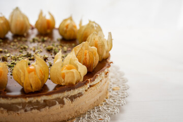 summer cake sweet baked dessert physalis chocolate caramel cheesecake with pistacios sprinkle on top 