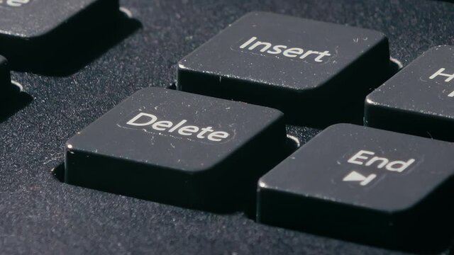 the finger presses the delete key several times. various pressing of the delete key. single clicks.