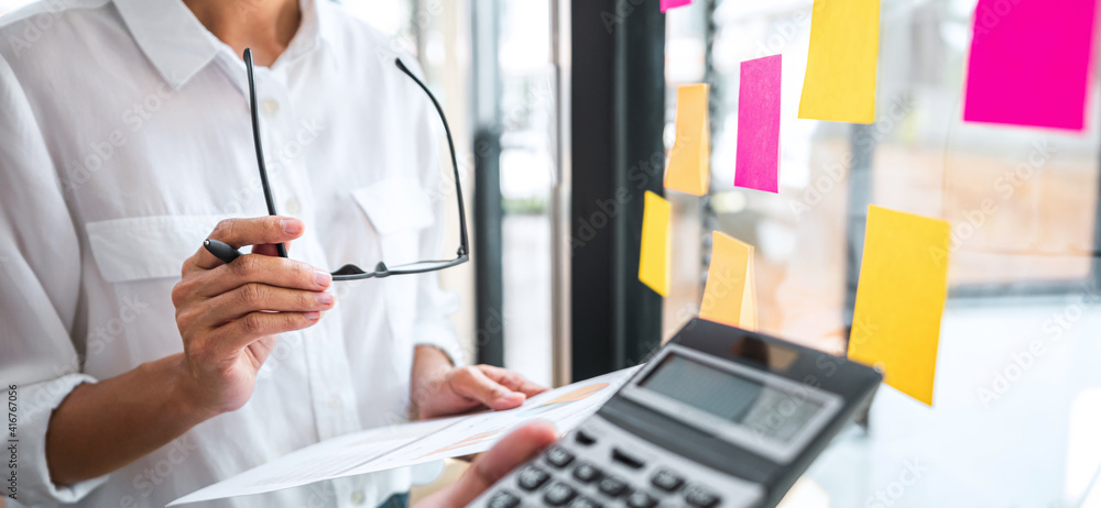 Poster business team working marketing growth on financial document graph report statistics, using post it 