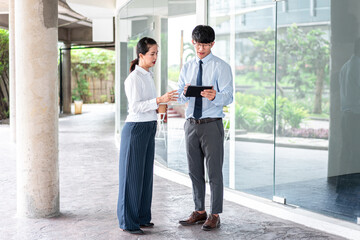 Young business partner using tablet to talking about business project