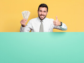 young handsome businessman with dollar banknotes. wealth concept