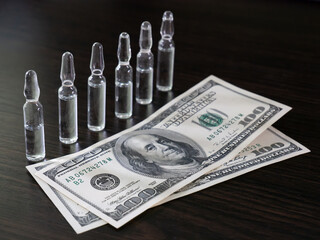 Ampoules and money dollar, hundred